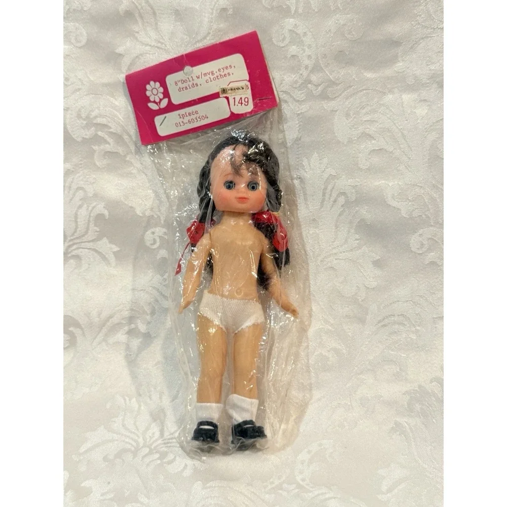 vintage 8-inch doll from Frank's with movable eyes, braids, and white panties.